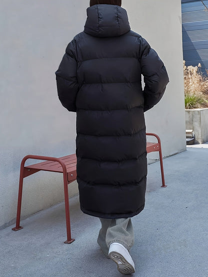 Women's Long Black Puffer Jacket with Hood and Full-Length Quilted Design